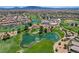Aerial view of a golf course community, with ponds and lush greenery surrounding the residential area at 1264 Olivia Pkwy, Henderson, NV 89011