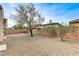 Low-maintenance backyard with decorative gravel, brick wall, and mature landscaping at 1264 Olivia Pkwy, Henderson, NV 89011