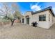 Private gravel backyard featuring a grill and access to patio at 1264 Olivia Pkwy, Henderson, NV 89011