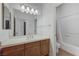 Bathroom featuring a large mirror, vanity with sink, and a bath-shower combination at 1264 Olivia Pkwy, Henderson, NV 89011