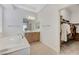 Bathroom featuring a vanity, soaking tub, and a walk-in closet at 1264 Olivia Pkwy, Henderson, NV 89011