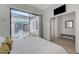 Well lit bedroom featuring a view to the backyard patio through sliding glass doors at 1264 Olivia Pkwy, Henderson, NV 89011