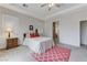 Bright bedroom features a ceiling fan, red accent pillows, and neutral paint at 1264 Olivia Pkwy, Henderson, NV 89011