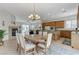 Bright dining area with a wood table, six chairs, and a view of the fireplace and living room at 1264 Olivia Pkwy, Henderson, NV 89011