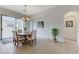 Bright dining area featuring a wood table, comfortable chairs, and sliding glass door with natural light streaming in at 1264 Olivia Pkwy, Henderson, NV 89011