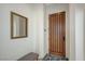 Elegant entryway with a solid wood front door, mirror, neutral walls and patterned rug at 1264 Olivia Pkwy, Henderson, NV 89011