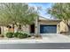 Charming single story home with well maintained landscaping and a blue garage door at 1264 Olivia Pkwy, Henderson, NV 89011