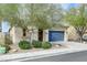 Charming single story home with desert landscaping, and a blue garage door at 1264 Olivia Pkwy, Henderson, NV 89011