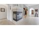Modern fireplace with a tiled surround, built-in shelving, and an open layout flowing into the living spaces at 1264 Olivia Pkwy, Henderson, NV 89011