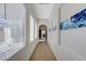 Bright hallway with tiled flooring, arched doorways, and serene artwork at 1264 Olivia Pkwy, Henderson, NV 89011