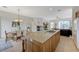 Open-concept kitchen with island, dining area, fireplace, and access to outdoor living space at 1264 Olivia Pkwy, Henderson, NV 89011