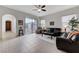 Inviting living room featuring tile floors, comfortable seating, and a sliding door leading to the outdoor patio at 1264 Olivia Pkwy, Henderson, NV 89011