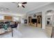 Spacious living room with fireplace, tiled flooring, open layout, and seamless flow into the kitchen and dining area at 1264 Olivia Pkwy, Henderson, NV 89011