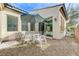 Charming backyard patio with a four-chair table set and gravel landscaping at 1264 Olivia Pkwy, Henderson, NV 89011