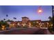 The private community entrance features an ornate brick tower and is landscaped with palm trees at 1273 Olivia Parkway Pkwy, Henderson, NV 89011