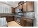 Updated kitchen features granite countertops, stainless steel appliances, and dark wood cabinets at 1273 Olivia Parkway Pkwy, Henderson, NV 89011