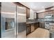 Modern kitchen features stainless steel appliances, granite counters and dark wood cabinets at 1273 Olivia Parkway Pkwy, Henderson, NV 89011