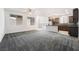 Open-concept living space featuring plush carpet, natural light, and an open kitchen area at 1273 Olivia Parkway Pkwy, Henderson, NV 89011
