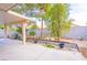 Expansive back patio, complete with desert landscaping and mature trees, creating a private outdoor retreat at 1309 Misty View Ct, North Las Vegas, NV 89031
