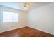 Bright bedroom with hardwood floors, a ceiling fan, and a large window providing plenty of natural light at 1309 Misty View Ct, North Las Vegas, NV 89031