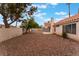 Wide backyard with gravel, desert landscaping, hardscape patio, and block wall fence at 1335 Heather Oaks Way, North Las Vegas, NV 89031