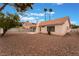Backyard with gravel, hardscape patio, block wall fence, and desert landscaping at 1335 Heather Oaks Way, North Las Vegas, NV 89031