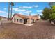 Exterior of home with gravel-covered backyard and enclosed by block wall fence at 1335 Heather Oaks Way, North Las Vegas, NV 89031
