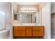 Bathroom featuring double sinks, cabinets, and a large mirror, with ample lighting above at 1335 Heather Oaks Way, North Las Vegas, NV 89031
