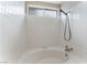 Bathroom with a bathtub featuring white tile surround and modern fixtures for a clean aesthetic at 1335 Heather Oaks Way, North Las Vegas, NV 89031