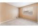 Bedroom with neutral carpet and paint, complemented by a window offering natural light at 1335 Heather Oaks Way, North Las Vegas, NV 89031
