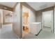 Hallway view to bathroom with shower over tub, additional rooms, and cabinet at 1335 Heather Oaks Way, North Las Vegas, NV 89031