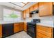 Efficient kitchen offering white countertops, ample wood cabinetry and black appliances at 1335 Heather Oaks Way, North Las Vegas, NV 89031