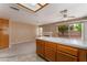Open layout with kitchen island, carpet, and backyard access at 1335 Heather Oaks Way, North Las Vegas, NV 89031
