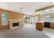 Bright living room featuring a fireplace, neutral colors, and sliding glass doors to the backyard at 1335 Heather Oaks Way, North Las Vegas, NV 89031