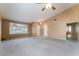 Spacious living room featuring neutral paint, plush carpet flooring, and a large window at 1335 Heather Oaks Way, North Las Vegas, NV 89031