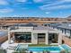 Aerial view of a modern home with a pool, outdoor dining area, and rooftop terrace at 144 Tre Pietre St, Henderson, NV 89011