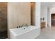 Bright bathroom featuring a soaking tub with sleek fixtures and neutral tile work at 144 Tre Pietre St, Henderson, NV 89011