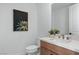 Bright bathroom featuring a modern vanity, white countertops, and a decorative painting at 144 Tre Pietre St, Henderson, NV 89011