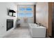 Modern bathroom with a soaking tub, sleek fixtures, large windows, and a minimalist design for a spa-like experience at 144 Tre Pietre St, Henderson, NV 89011