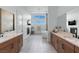 Expansive bathroom with dual vanities, fireplace, and soaking tub with bright sunlight at 144 Tre Pietre St, Henderson, NV 89011