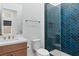 Modern bathroom with glass enclosed shower featuring stunning blue herringbone tile at 144 Tre Pietre St, Henderson, NV 89011
