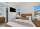 Cozy bedroom with bedside tables, large windows, and view to ensuite bathroom at 144 Tre Pietre St, Henderson, NV 89011