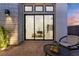 Modern home exterior featuring a sliding glass door that leads to an outdoor patio area at 144 Tre Pietre St, Henderson, NV 89011
