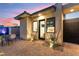 Beautiful exterior view of a modern home with outdoor seating area at sunset at 144 Tre Pietre St, Henderson, NV 89011