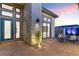 Stylish home entrance with a modern door, stone accents, and charming seating area featuring a decorative water feature at 144 Tre Pietre St, Henderson, NV 89011