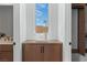 A transitional hallway with white walls, wood storage cabinets, and a view to the outside at 144 Tre Pietre St, Henderson, NV 89011