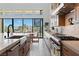 Bright open kitchen with stainless steel appliances, an island, and a view of the pool area at 144 Tre Pietre St, Henderson, NV 89011