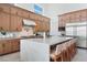 Spacious kitchen with custom cabinets, a large island, and stainless steel appliances under natural light at 144 Tre Pietre St, Henderson, NV 89011