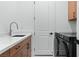 Well-lit laundry room with modern washer/dryer, white countertops and shaker cabinets at 144 Tre Pietre St, Henderson, NV 89011