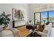 Bright living room with a textured rug, stylish furnishings, and sliding doors to a pool view at 144 Tre Pietre St, Henderson, NV 89011